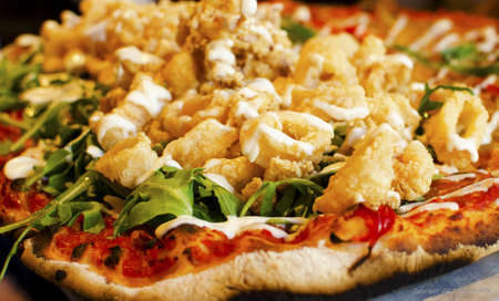 Delicious pizza close up on wooden board and concepts. Italian national food.の写真素材