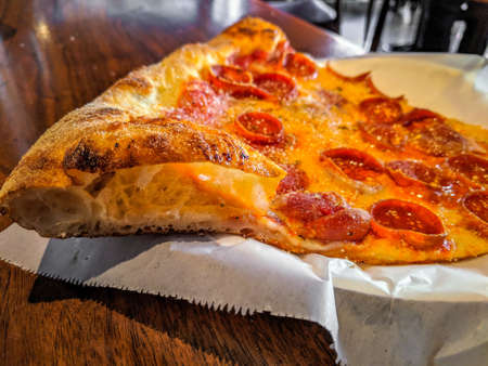 Delicious pizza close up on wooden board and concepts. Italian national food.
