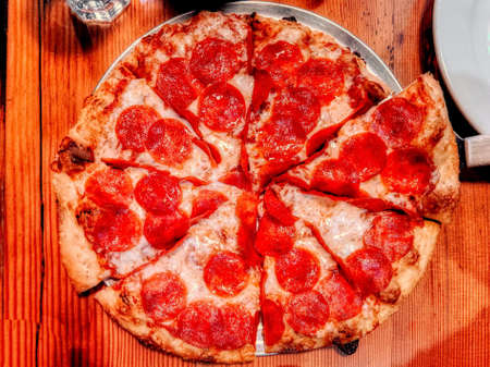 Delicious pizza close up on wooden board and concepts. Italian national food.の写真素材