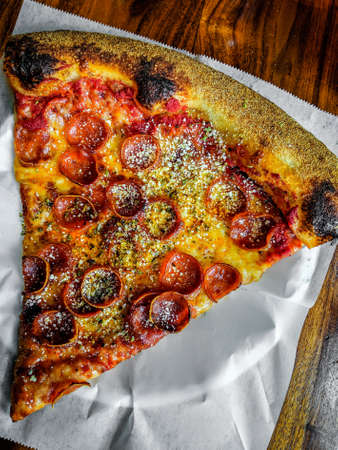 Delicious pizza close up on wooden board and concepts. Italian national food.の写真素材