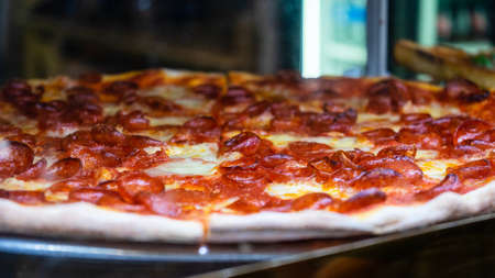 Delicious pizza close up on wooden board and concepts. Italian national food.の写真素材