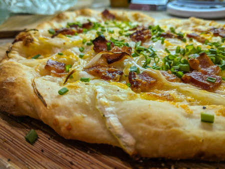 Delicious pizza close up on wooden board and concepts. Italian national food.の写真素材