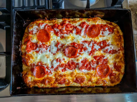 Delicious pizza close up on wooden board and concepts. Italian national food.の写真素材