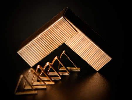 Copper staples on black shine surface