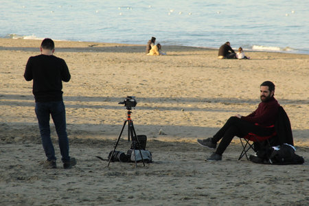 Samsun,Turkey - November 27, 2022 Two guys creating a vlog at seaside. high quality photo