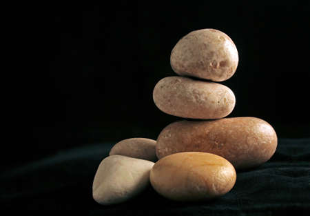 Arrangement with pebbles on dark backgroundの写真素材