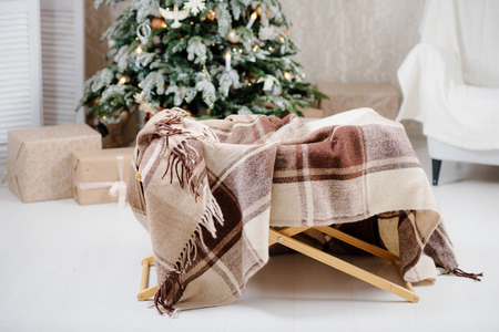 The bed standing near  Christmas tree with giftsの写真素材