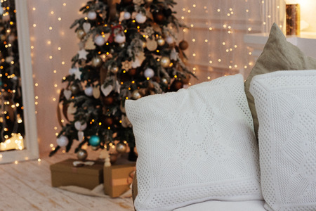 Christmas tree with vintage decorations near fireplace with lightsの写真素材