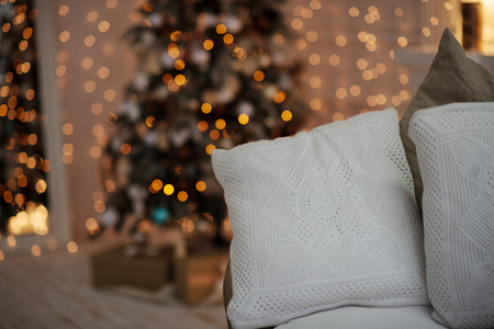 Christmas tree with vintage decorations near fireplace with lightsの写真素材