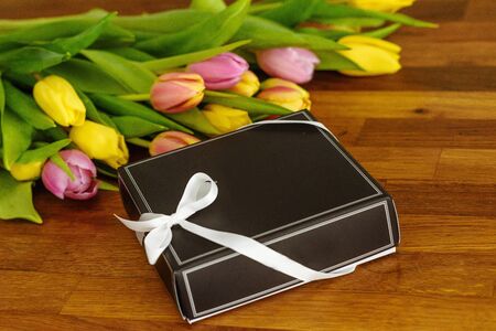 Close up of red tulips and chocolate box