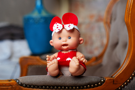 cute doll on a light textile clothing naturalの写真素材