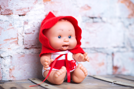 cute doll on a light textile clothing naturalの写真素材