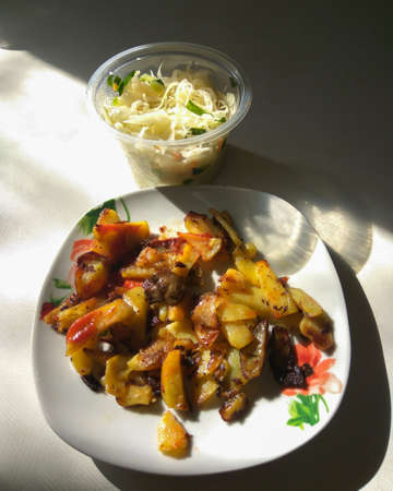 Fried potatoes with mushroomsの写真素材