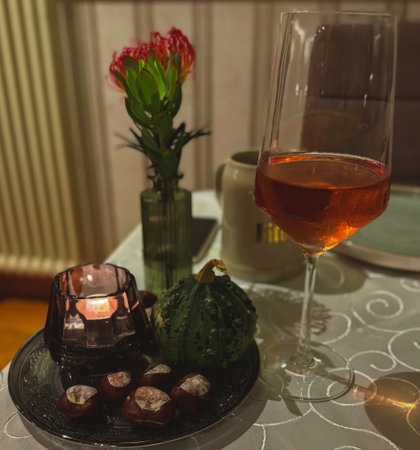 Cozy autumn still life with wine and candleの写真素材