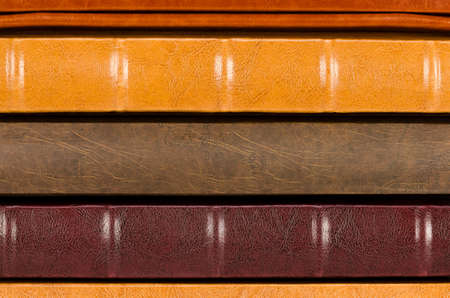 Stack of leather photo albums isolated on white background close-up. Horizontal shotの写真素材