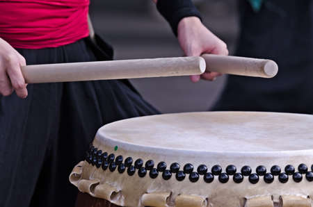Group of japanese musicians are playing on traditional japanese percussion instrument Taiko or...
