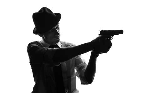 Silhouette of a private detective with two guns in both handsの写真素材