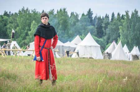 MOSCOW,RUSSIA-June 06,2016: Man in ancient merchant costume stands on green field of grassのeditorial素材