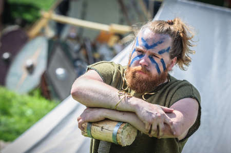 MOSCOW,RUSSIA-June 06,2016: Ancient viking warrior with painted face and big hammer in his hands.のeditorial素材