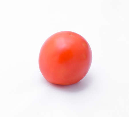 one fresh tomato isolated on white backgroundの写真素材