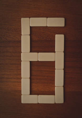 number zero laid out the domino chips on a wooden tableの写真素材