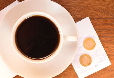 coffee on a wooden table with moneyの写真素材
