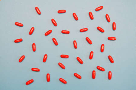 White medical pills on blue background.の写真素材