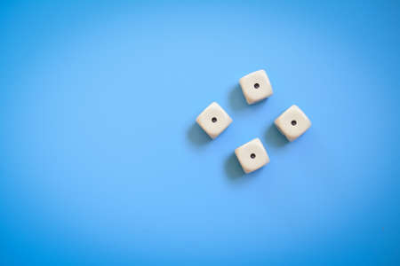 Four dice number one on a blue background