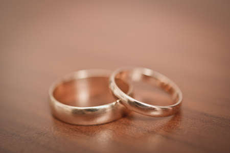 two wedding rings on the tableの写真素材