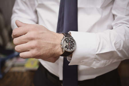 man puts his hand on the clockの写真素材