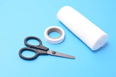medical set: a plaster, bandage scissors, isolated on a blue background. Blade abstract.の写真素材
