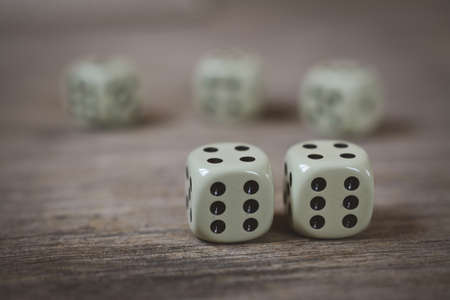 two dice number double six on a wooden tableの写真素材