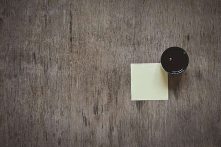 one small sheet of paper on bulletin cork board isolatedの写真素材