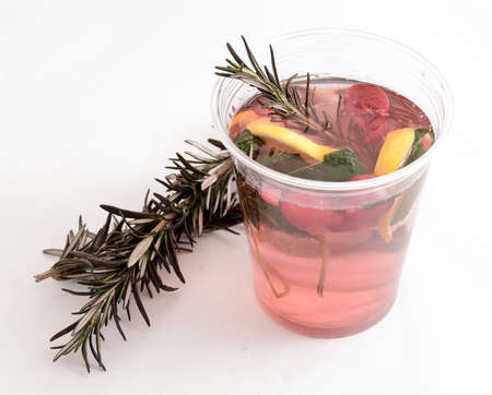 Cup of Hot tea with fruit and spices. Black fruit tea on whiteの写真素材