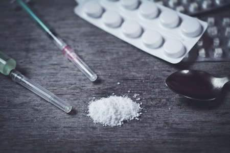 Hard drugs on dark table