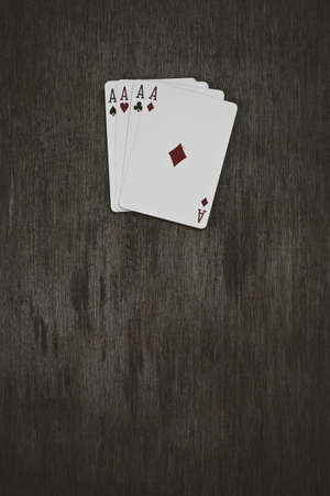 four aces playing cards on a wooden background. risk, luck, abstraction. Space for your text or objectの写真素材