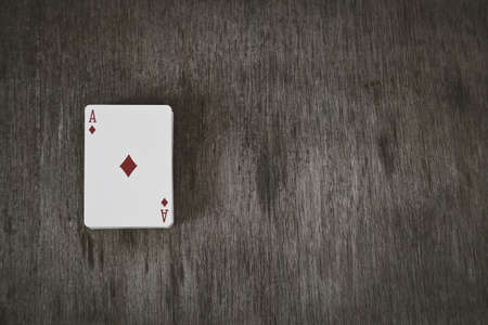 Ace of diamonds. playing cards on a wooden background. Risk and Gambling background, abstractの写真素材