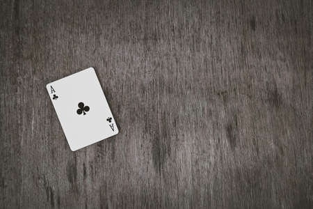 ace of clubs closeup, playing cards on a wooden background. Risk and Gambling background, abstract and game concept. space for text.の写真素材