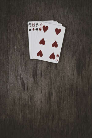 playing cards four six closeup on a wooden table. space for text. copyspace. game abstract and concept.の写真素材