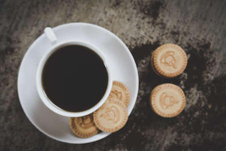 cookies and cup of hot coffee on old wooden table. Top viewの写真素材