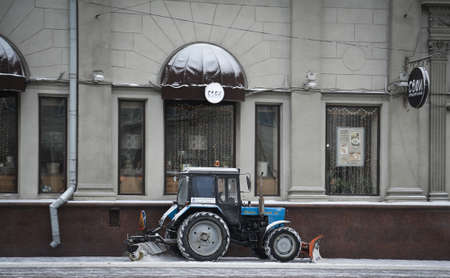MINSK, BELARUS - January 11, 2017. Belarus tractor cleans snow on the sidewalk along Independence Avenue in Minsk.のeditorial素材