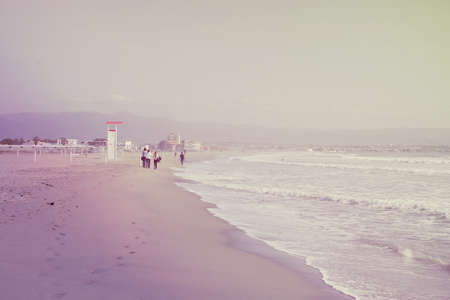 People walk on a deserted beachの写真素材