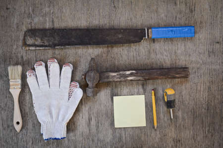 machetes and gloves, hammer and an old notebook for recording. tools for repair. two brushes for the paintの写真素材