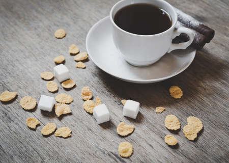 cop of coffee with sugar cubes on the wooden tableの写真素材