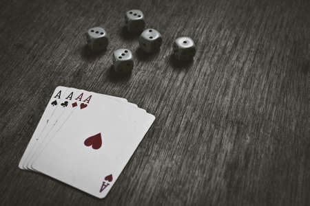 four aces playing cards and dice with copyspace, game abstract background