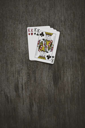 playing cards four kings. wooden background. game abstract.の写真素材