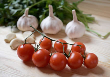 Sweet tomatoes on wooden background, garlic. food abstractの写真素材