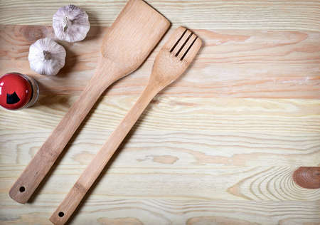 Kitchen utensils on shelf against rustic wooden wallの写真素材