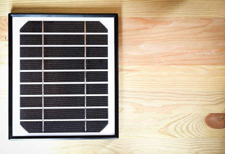 small solar panel on the wooden table with copyspace, green energy abstractの写真素材
