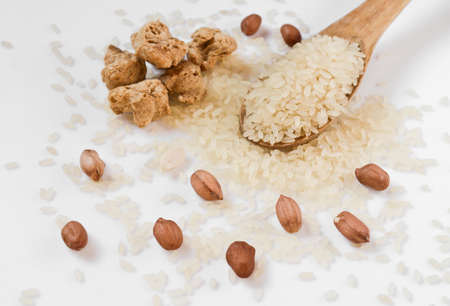 soy meat and a wooden spoon with rice and peanuts, diet food abstractの写真素材